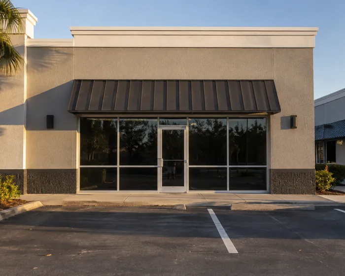 Freshly repainted commercial unit exterior with a metal awning, Gibsonton